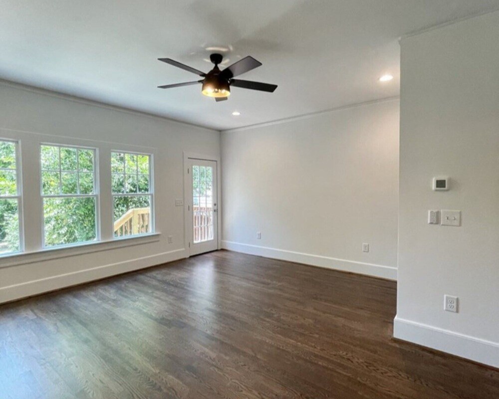 Family room addition with wood floors and a ceiling fan