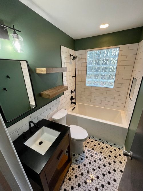 Bathroom with subway tile shower and black hardware