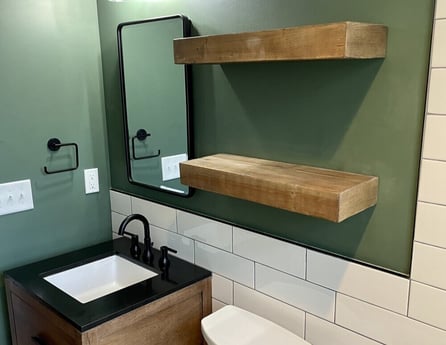 Bathroom with subway tile walls and black hardware