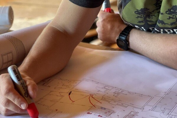 Bald Cypress employee drawing on blueprint