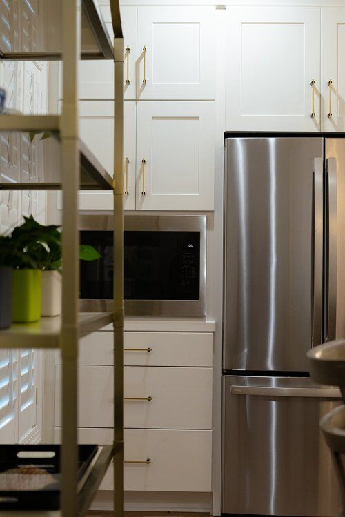 Kitchen remodel with white cabinets and stainless steel appliances